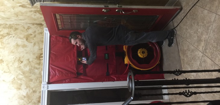 Running a blower door test during energy audit